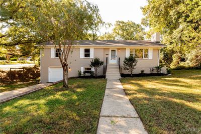 View of front of property featuring a front lawn and a garage | Image 1