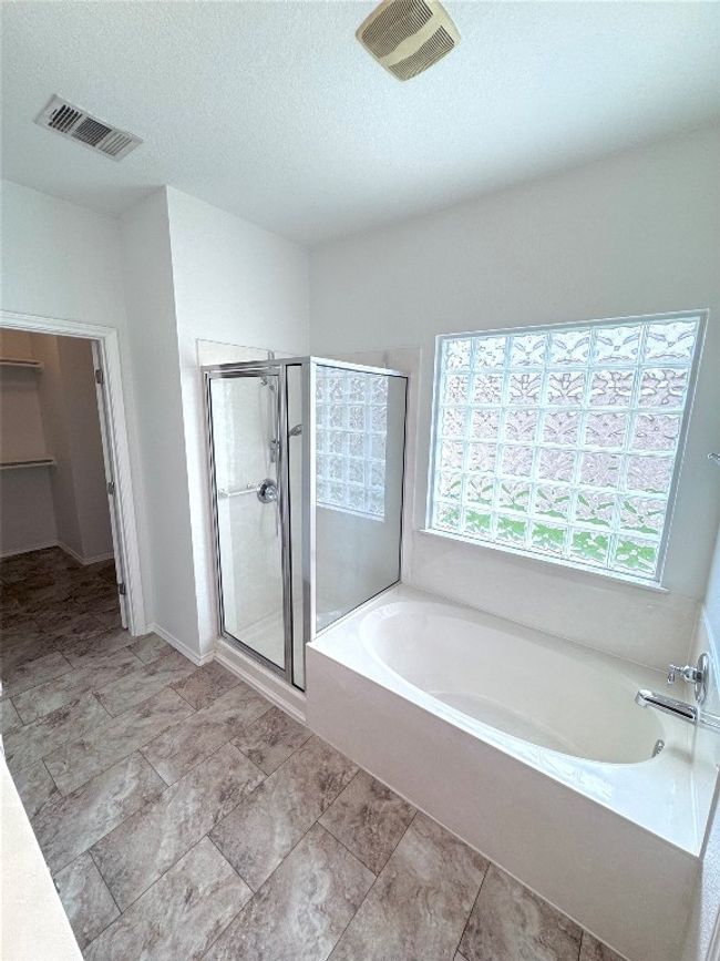 Full bathroom with a bath, a stall shower, and a textured ceiling | Image 17