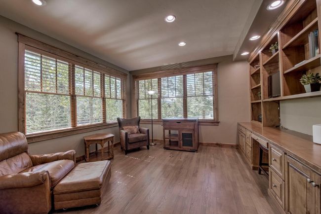 The main level office has beautiful built-in bookshelves and plentiful natural light. | Image 12
