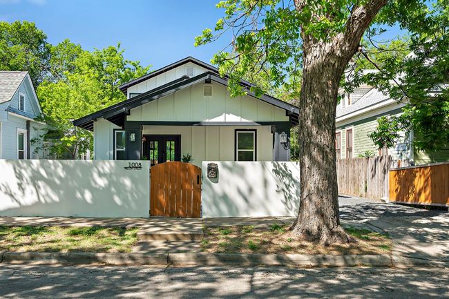 Bungalow featuring board and batten siding, french doors, a gate, and a fenced front yard | Image 34