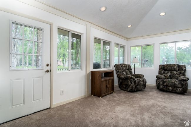 Sitting room with carpet, recessed lighting, and lofted ceiling | Image 16