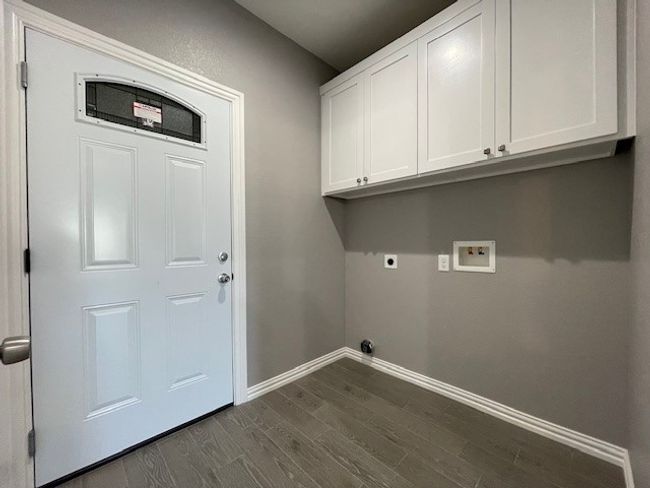 Laundry room with hookup for a washing machine, ceramic wood-style flooring, baseboards, cabinet space, and electric dryer hookup | Image 15