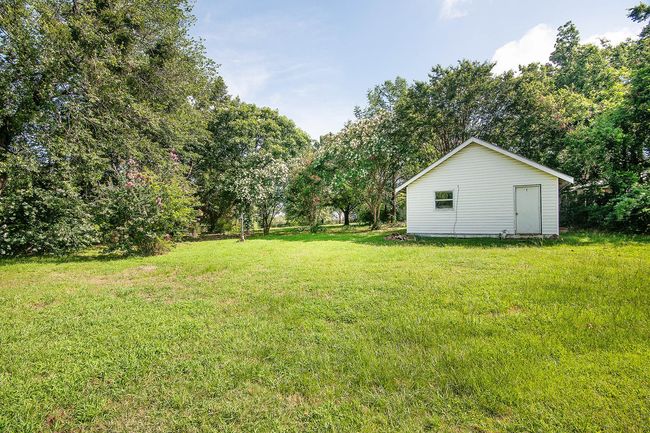 View of green lawn with an outbuilding | Image 31