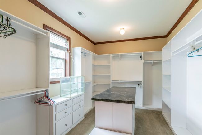 Spacious closet with visible vents and light colored carpet | Image 15
