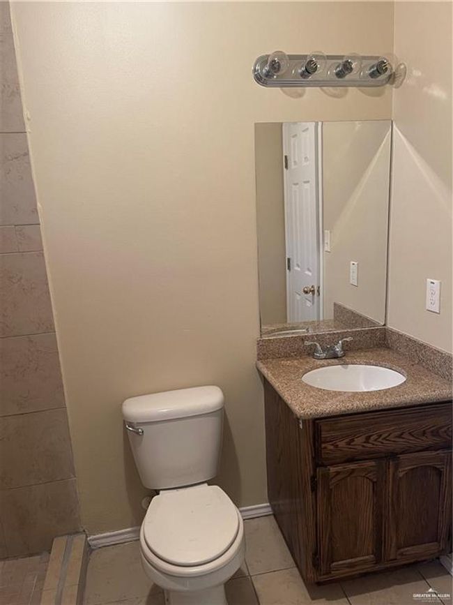 Bathroom with toilet, vanity, and tile patterned floors | Image 8