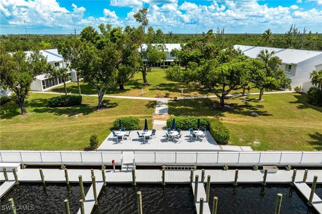 View of dock with a lawn and a patio area | Image 39