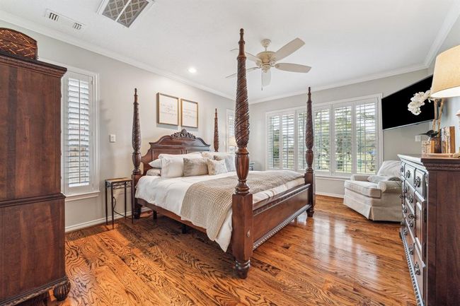Spacious primary bedroom with wonderful views of the backyard and park. | Image 17