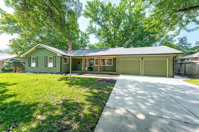 Ranch-style home with a garage and a front yard | Image 3