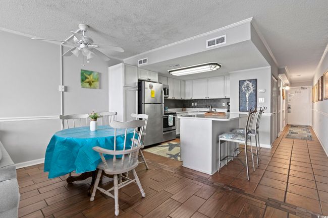 Kitchen featuring backsplash, stainless steel appliances, ceiling fan, and visible vents | Image 21