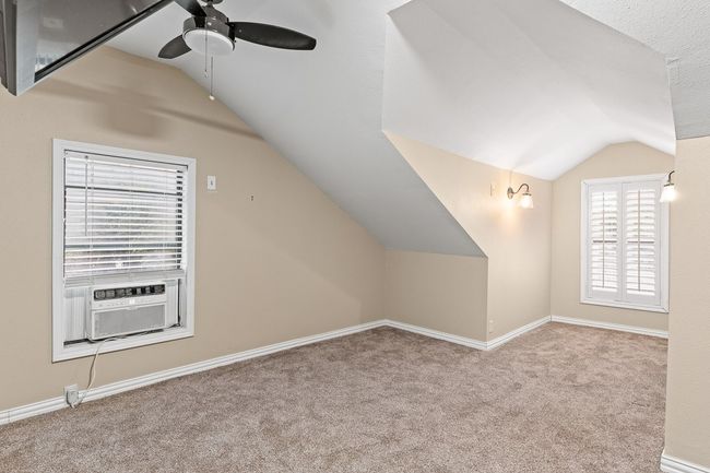 Additional living space featuring vaulted ceiling, a ceiling fan, carpet flooring, cooling unit, and baseboards | Image 32