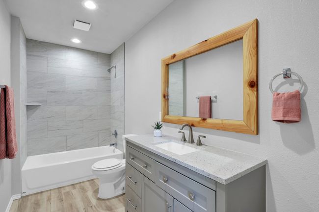 Full bathroom featuring vanity, wood finished floors, tub / shower combination, and recessed lighting | Image 15
