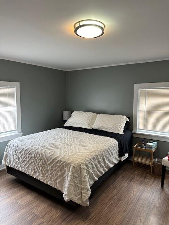 Bedroom with dark hardwood / wood-style flooring | Image 12