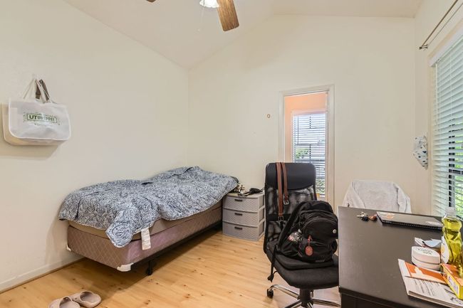 Bedroom with multiple windows, vaulted ceiling, and wood finished floors | Image 16