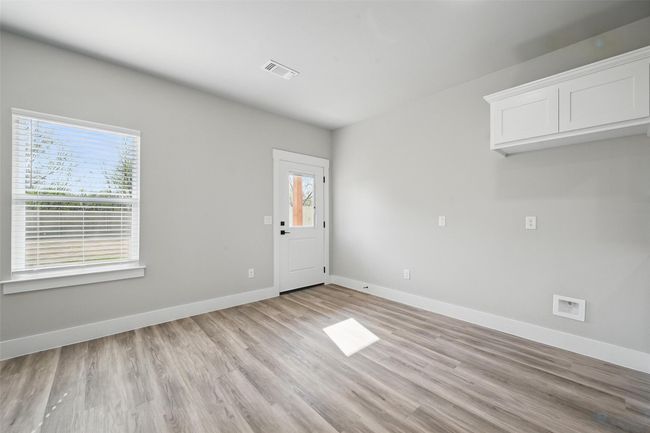 Spare room featuring light wood finished floors, baseboards, and visible vents | Image 17