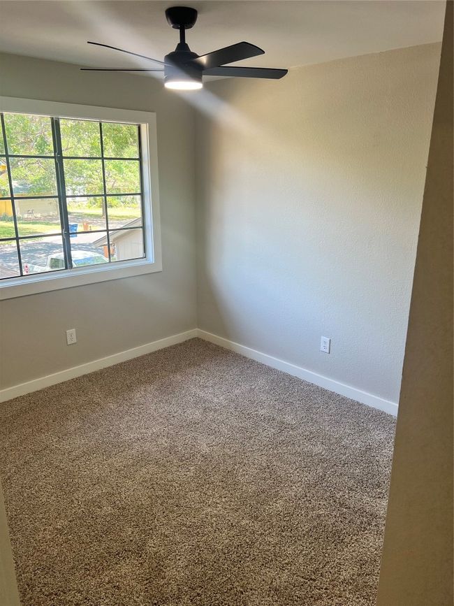 Carpeted empty room with a ceiling fan and baseboards | Image 17