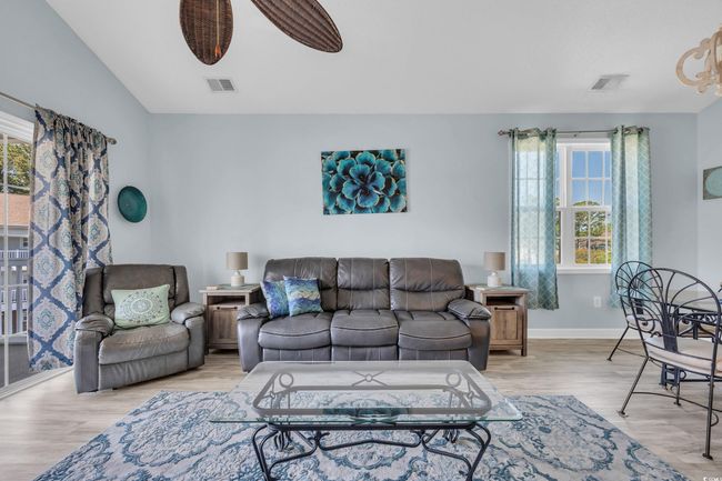 Living room with light wood-style floors, visible vents, and baseboards | Image 15