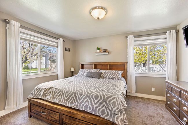 Bedroom featuring baseboards and light carpet | Image 17
