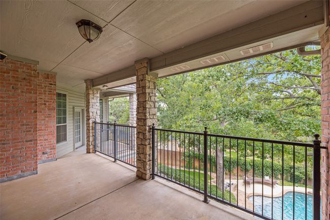 Large balcony overlooking backyard with access from both primary bedroom and a secondary bedroom. | Image 19