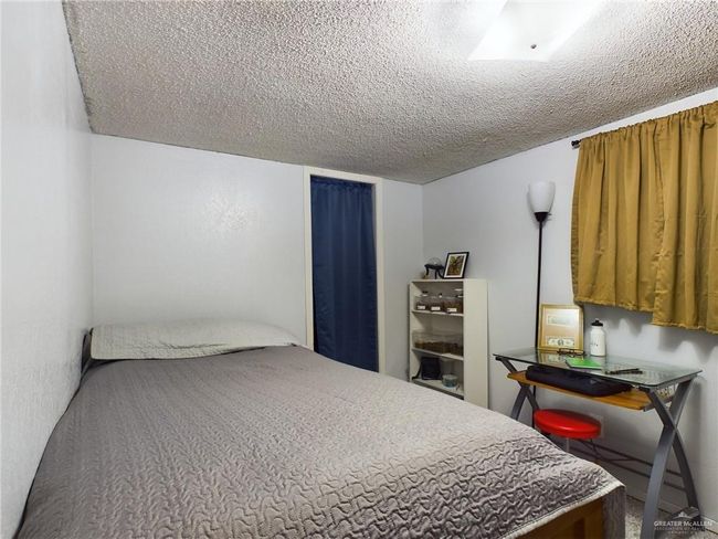 Bedroom with a textured ceiling | Image 19
