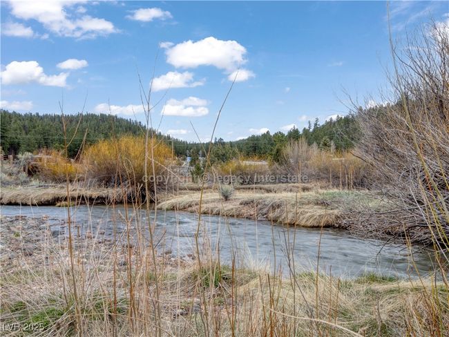 Property view of water with a view of trees | Image 43