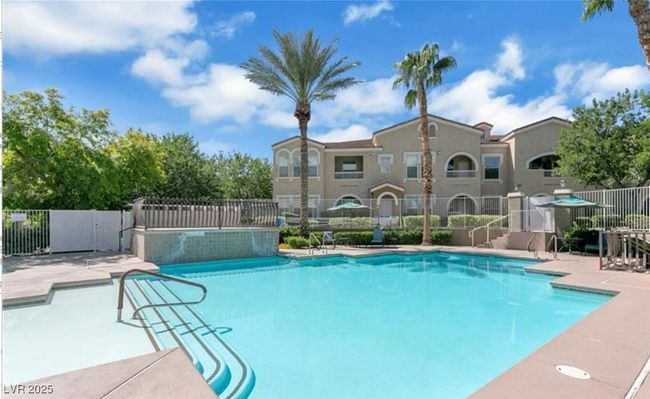 Community pool with fence and a patio area | Image 22