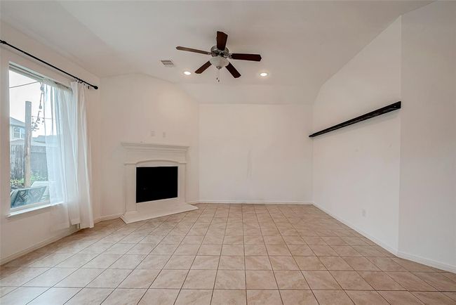 Spacious living area with views to back yard high ceiling and can lights | Image 4
