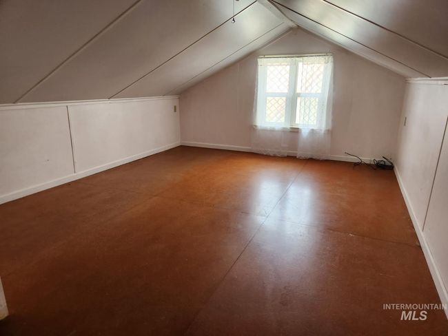 Additional living space with lofted ceiling and finished concrete floors | Image 12