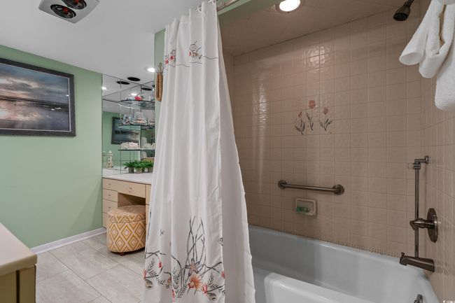 Bathroom with baseboards, shower / bath combination with curtain, tile patterned flooring, and vanity | Image 25