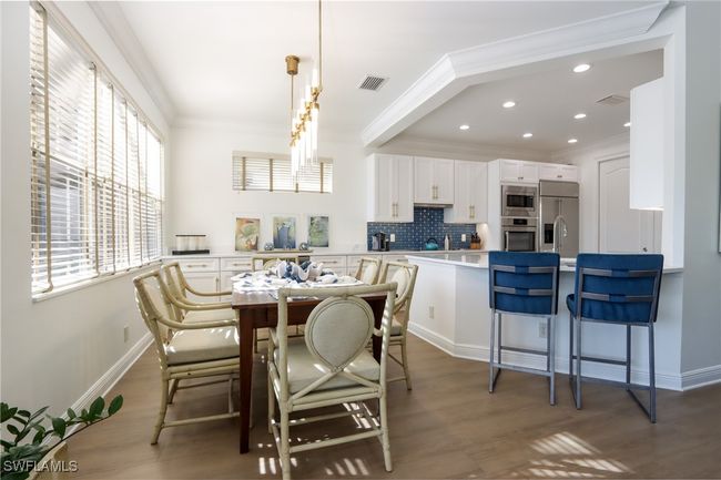 Dining room featuring crown molding, wood finished floors, and recessed lighting | Image 5