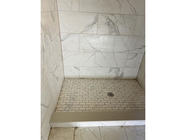 Bathroom featuring a tile shower | Image 7