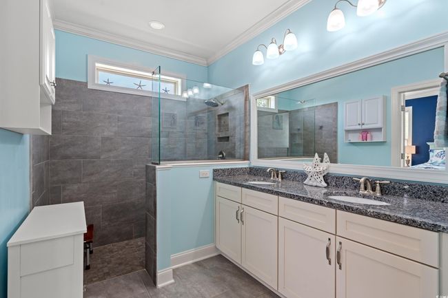 Full bath with double vanity, a walk in shower, and ornamental molding | Image 19