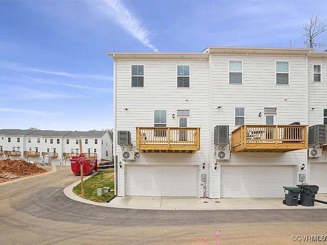 Back of property featuring a garage and a balcony | Image 4