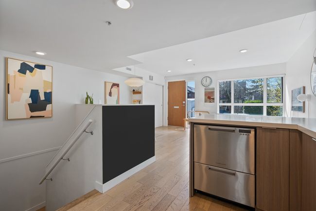 Kitchen with recessed lighting, light countertops, light wood-style floors, modern cabinets, and brown cabinetry | Image 12
