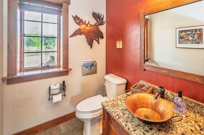 Half bathroom with toilet, baseboards, and vanity | Image 48
