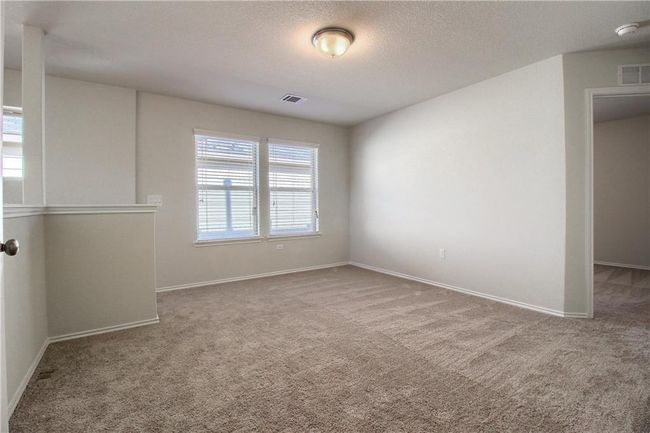 Empty room featuring carpet floors, a smoke detector, baseboards, and a textured ceiling | Image 20