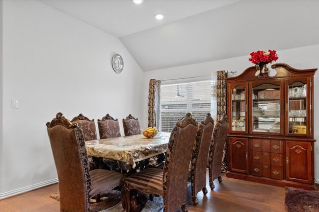 Dining room with lofted ceiling, wood finished floors, and recessed lighting | Image 13