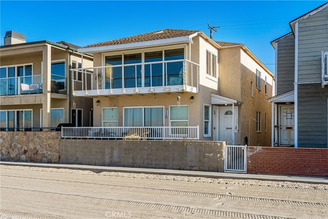 Charming beachfront home with an inviting balcony and direct access to the sand | Image 7
