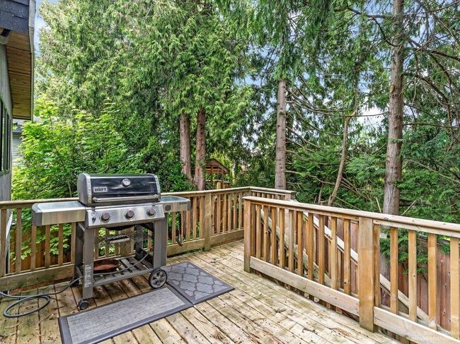 Beautiful Back deck off the kitchen and solarium with stairs down to the back yard. There is a workshop/storage area discreetly hidden in a recessed area underneath the solarium. | Image 20