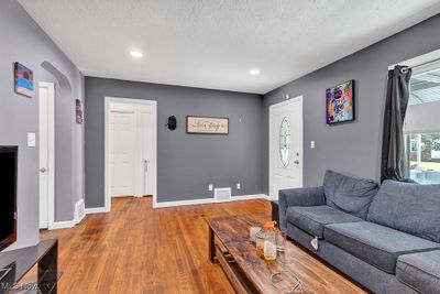 Living room with a textured ceiling and hardwood / wood-style flooring | Image 2