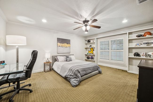 Split bedroom with built-in shelves and walk in closet with en suite bathroom. | Image 17