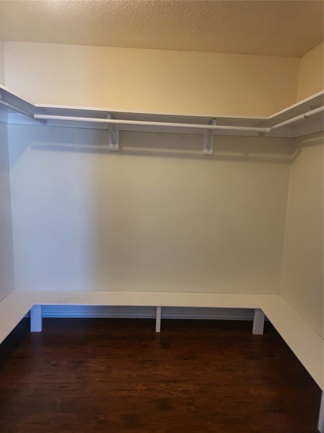 Walk in closet featuring wood finished floors | Image 16