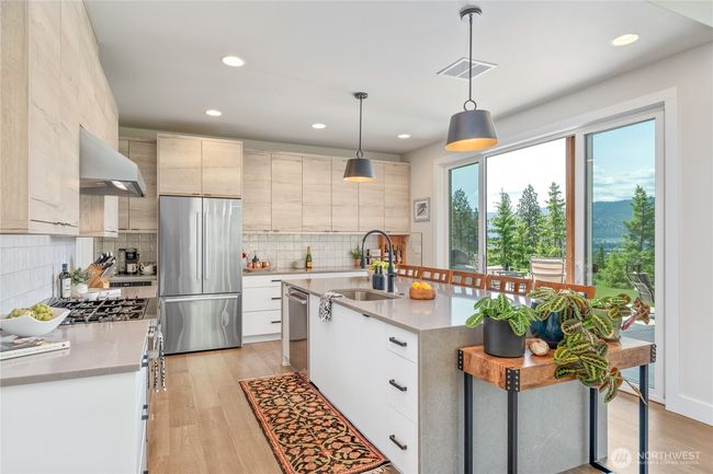 Enjoy seamless indoor-outdoor living with direct access to the expansive covered rear patio, ideal for entertaining against a stunning mountain backdrop | Image 9