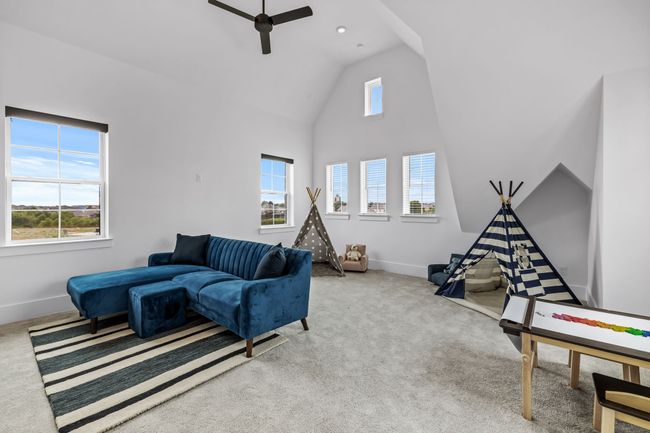 Living room featuring ceiling fan, carpet floors, and plenty of natural light | Image 27