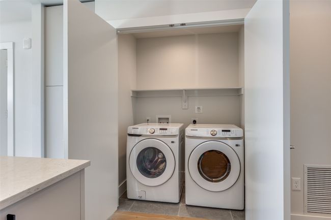 Laundry room featuring light tile patterned floors and independent washer and dryer | Image 11