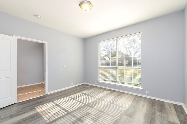 Spare room with baseboards and wood finished floors | Image 18