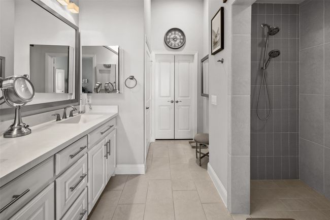 Full bathroom with tiled shower, tile patterned flooring, vanity, and baseboards | Image 12
