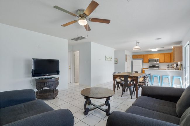 Living area featuring visible vents, ceiling fan, and light tile patterned floors | Image 12