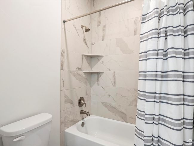 Bathroom with shower / bath combo and toilet | Image 39