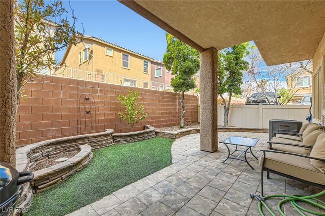 Additional view of the back patio with the enclosed/fenced backyard area at 7143 Cabin Fever St Unit 102 | Image 21