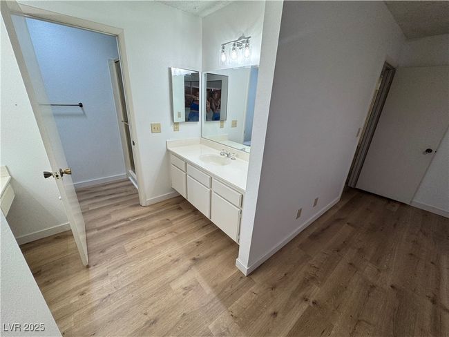 Full bathroom featuring vanity, wood finished floors, and a stall shower | Image 26
